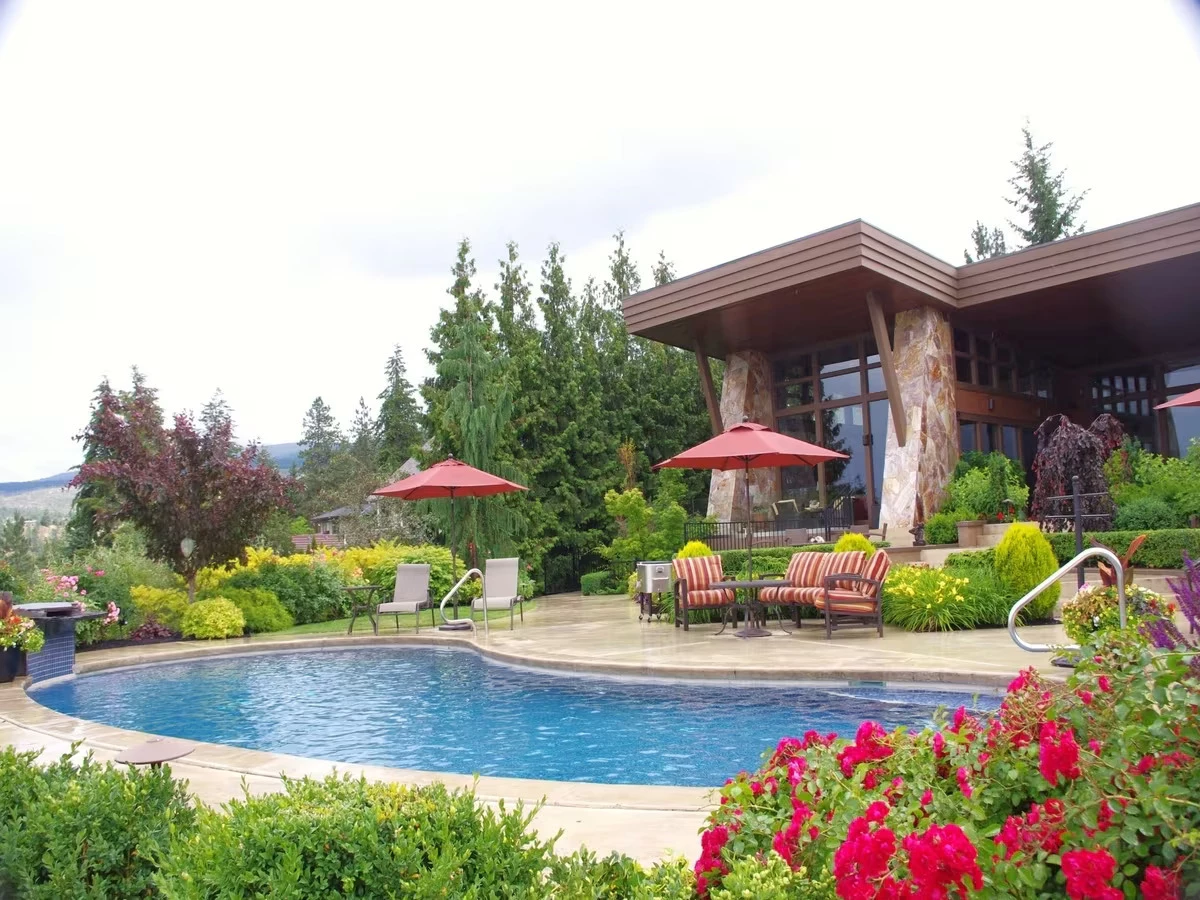 Beautiful landscaping around a pool done by Synergy Landscape Kelowna